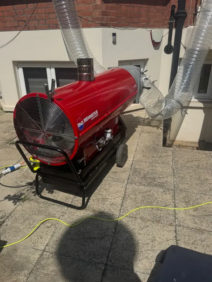 Close-up of an industrial heat treatment heater fan and ducting on a live job